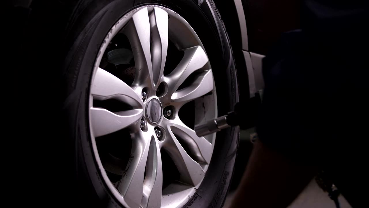 Technician inspecting a wheel